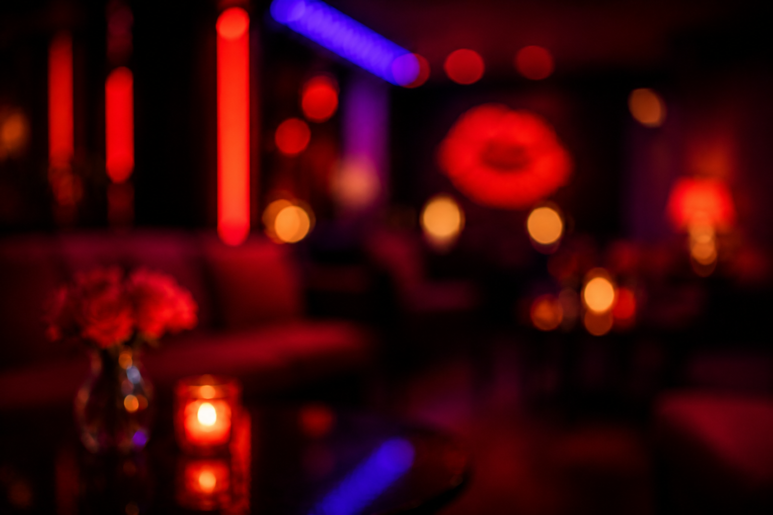 Blurred lounge with red candlelight and violet neon